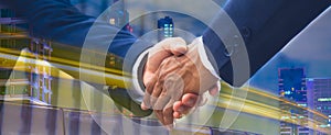 Banner header panoramic horizontal - close up businessmen shaking hands and handing down business deals in urban center, business