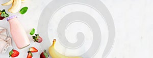 Banner with healthy strawberry banana smoothie corner border, top view over a white marble background