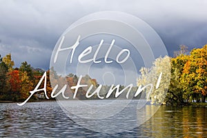 Banner hello autumn. New month. Greeting card. Golden autumn. Autumn in the park. The text in the photo. Trees in the autumn park