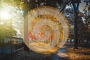 Banner hello autumn. New month. Greeting card. Golden autumn. Autumn in the park. The text in the photo. Trees in the autumn park