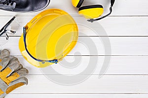 Banner image of construction safety equipment flat lay on white wooden