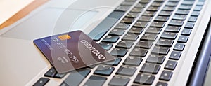 Banner image of credit card on computer keyboard. Online financial transaction for payment with technology and security concept