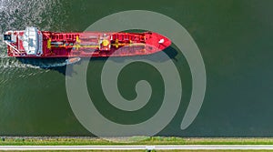 Banner of industrial fuel and petrochemical tanker being led by the pilot boat. Piloting service. Unknown waters. Banner top view