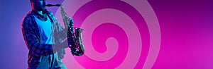 Banner. Jazzman playing on saxophone in neon light against gradient blue-pink background with negative space to insert