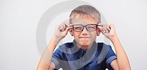 Banner little boy with glasses correcting myopia close-up portrait Ophthalmology problem selective focus