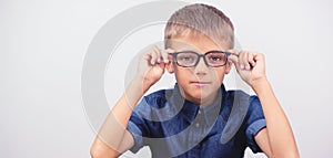 Banner little boy with glasses correcting myopia close-up portrait Ophthalmology problem selective focus