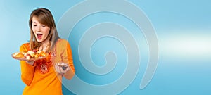 Banner, long format. An amazed woman eating sushi set, light blue background, blonde holding say sauce on a blue