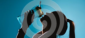 Banner, long format. Blacked-out portrait of a girl with long hair who drinking water against on blue background.