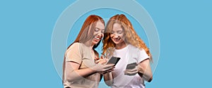 Banner, long format on blue background. Friendship. Two girls friends looking in smartphone, gossiping on slumber party