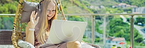 BANNER, LONG FORMAT Caucasian woman sitting on the terrace working from home using computer laptop. Young woman teaches