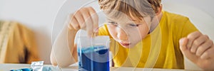 BANNER, LONG FORMAT Chemical home tests. Tools for the home lab. the boy Explorer. Child is watching a chemical reaction