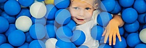 BANNER, LONG FORMAT Child playing in ball pit. Colorful toys for kids. Kindergarten or preschool play room. Toddler kid