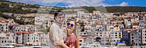 BANNER, LONG FORMAT Couple in love tourists enjoying the views of Architecture and luxury yachts in Lustica Bay