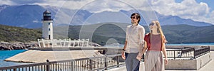 BANNER, LONG FORMAT Couple in love tourists enjoying the views of Architecture and luxury yachts in Lustica Bay