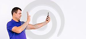 Banner,long format. A deaf man with a hearing aid waves his hand in front of the camera while communicating through