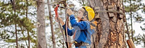 BANNER, LONG FORMAT Happy child in a helmet, healthy teenager school boy enjoying activity in a climbing adventure park