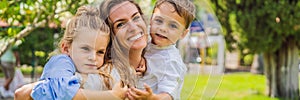 BANNER, LONG FORMAT Happy family outdoors on the grass in a park, smiling faces, having fun Portrait of a disgruntled
