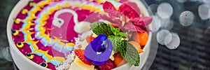 BANNER, LONG FORMAT Healthy tropical breakfast, smoothie bowl with tropical fruits, decorated with a pattern of colorful