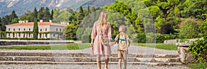 BANNER, LONG FORMAT Mom and son tourists walking together in Montenegro. Panoramic summer landscape of the beautiful