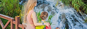 BANNER, LONG FORMAT Mother and son tourists on the background of Duden waterfall in Antalya. Famous places of Turkey