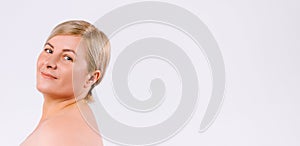 Banner,long format. Senior woman with healthy and moisturized skin posing at the camera and smiling. White background