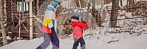 BANNER, LONG FORMAT Snowboard instructor teaches a boy to snowboarding wear medical masks due to the COVID-19