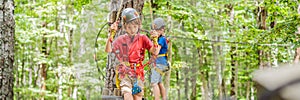 BANNER, LONG FORMAT Two boys in a helmet, healthy teenager school boy enjoying activity in a climbing adventure park on