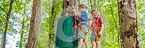 BANNER, LONG FORMAT Two boys in a helmet, healthy teenager school boy enjoying activity in a climbing adventure park on