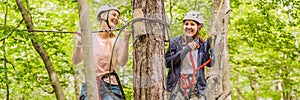 BANNER, LONG FORMAT Two women girls female gliding climbing in extreme road trolley zipline in forest on carabiner