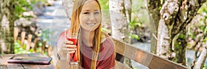 BANNER, LONG FORMAT Woman drinking healthy fruits and vegetables juice smoothie in summer. Happy girl enjoying organic