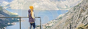 BANNER, LONG FORMAT Woman tourist enjoys the view of Kotor. Montenegro. Bay of Kotor, Gulf of Kotor, Boka Kotorska and