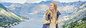 BANNER, LONG FORMAT Woman tourist enjoys the view of Kotor. Montenegro. Bay of Kotor, Gulf of Kotor, Boka Kotorska and