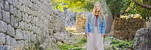 BANNER, LONG FORMAT Woman tourist enjoys the view of Kotor. Montenegro. Bay of Kotor, Gulf of Kotor, Boka Kotorska and