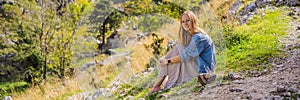 BANNER, LONG FORMAT Woman tourist enjoys the view of Kotor. Montenegro. Bay of Kotor, Gulf of Kotor, Boka Kotorska and