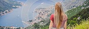 BANNER, LONG FORMAT Woman tourist enjoys the view of Kotor. Montenegro. Bay of Kotor, Gulf of Kotor, Boka Kotorska and