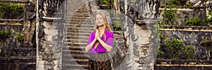 BANNER, LONG FORMAT Young woman tourist on background of Three stone ladders in beautiful Pura Lempuyang Luhur temple