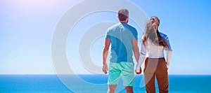 Banner of man and woman couple in love embracing at sunset or sunrise on sea beach, panoramic web poster of young couple