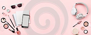 Banner mock up, woman`s cosmetics and phone on pink background.