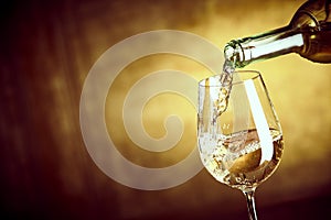 Banner ofPouring a glass of white wine from a bottle