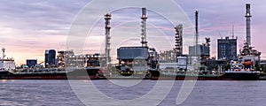 Banner of petroleum oil refinery plant beside river in twilight time
