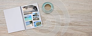 Banner Photobook Album on Deck Table with Travel Photos and Coffee or Tea in Cup