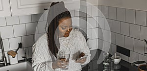 Banner Portrait of African American female student dressed casually holding mobile phone and typing messages and