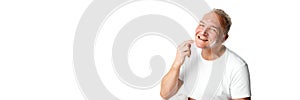 Banner. Portrait of middle aged, 45s man applying skin care cream on face against white background.