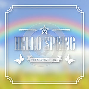 Banner, poster for design. Hi spring. Welcome. Against the background of a blurry sky, a green lawn, and a rainbow.