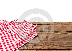 Banner of Red Checkered tablecloth top view  on white background. Brown wooden table. Selective focus. Copy space. Place