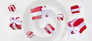 Banner red gift boxs with white satin ribbon bow flying on white background. Minimal concept for christmas holidays, birthday,