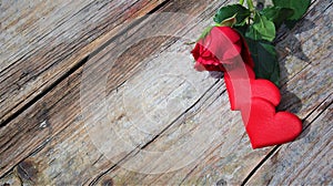 Banner. Red roses flowers with red hearts on old wooden background. Romantic Valentines holidays concept. Copy space. Top view