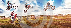 Banner rider on mountain dirtbike enduro participates in motocross, jumps on springboard against background dirt