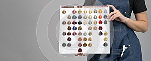 Banner shot with copy space. Women hairstylist holding color chart for customer selection for choose new hair dye color and style
