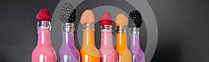 Banner of Six bottles with smoothies and raspberry